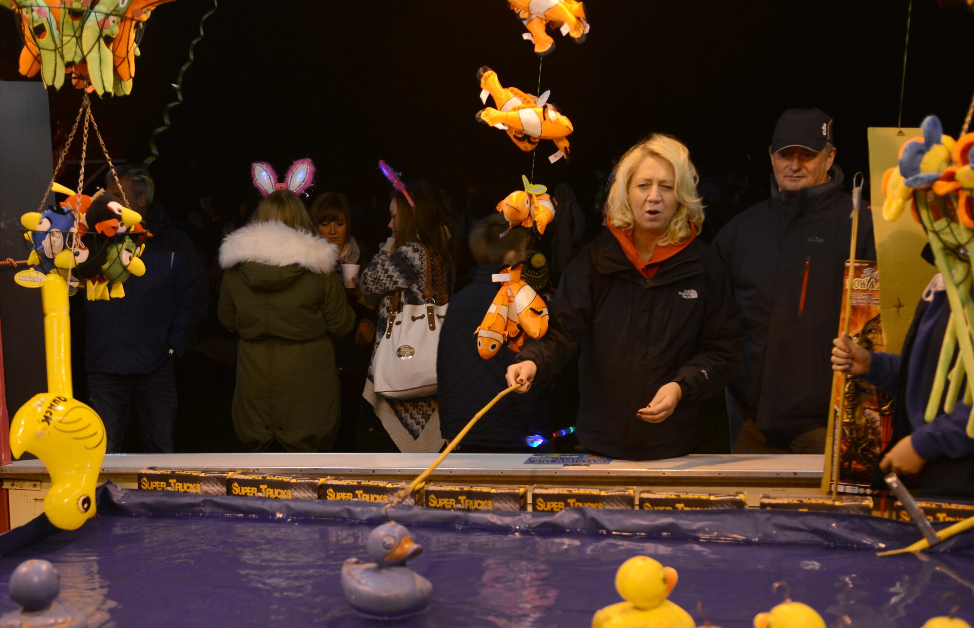 A fairgoer plays a duck-fishing game during a Bonfire Night celebration Nov. 2, 2013, at the Abbey Gardens in Bury St. Edmunds, England. There was a fair held with prizes and games during the celebration. Team Mildenhall members helped patrol the grounds to ensure people were abiding by the rules and not getting too close to the fireworks. (U.S. Air Force photo by Airman 1st Class Dillon Johnston/Released)