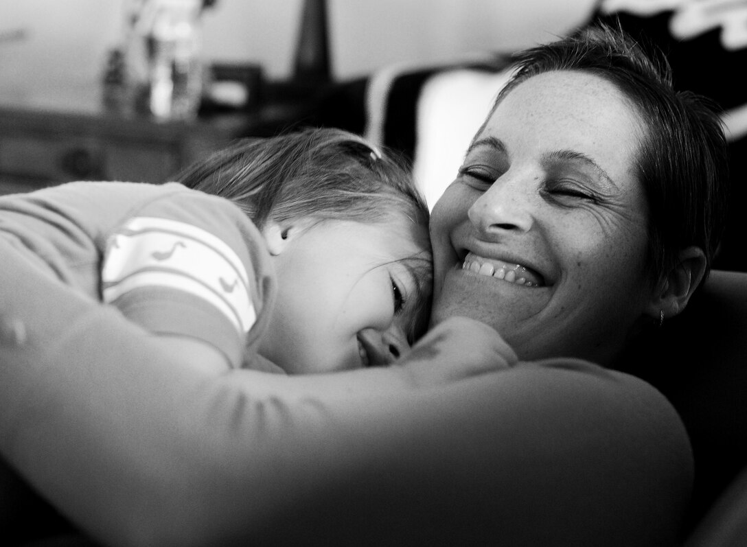 Brandi Jackson embraces her daughter Elsie while relaxing at their home on Oct. 29, 2013 at Joint Base Andrews, Md. After being diagnosed with breast cancer, Jackson leaned on her family, friends and church family for support, ensuring her two children were taken care of while she received treatment. (U.S. Air Force photo/Staff Sgt. Nichelle Anderson) 