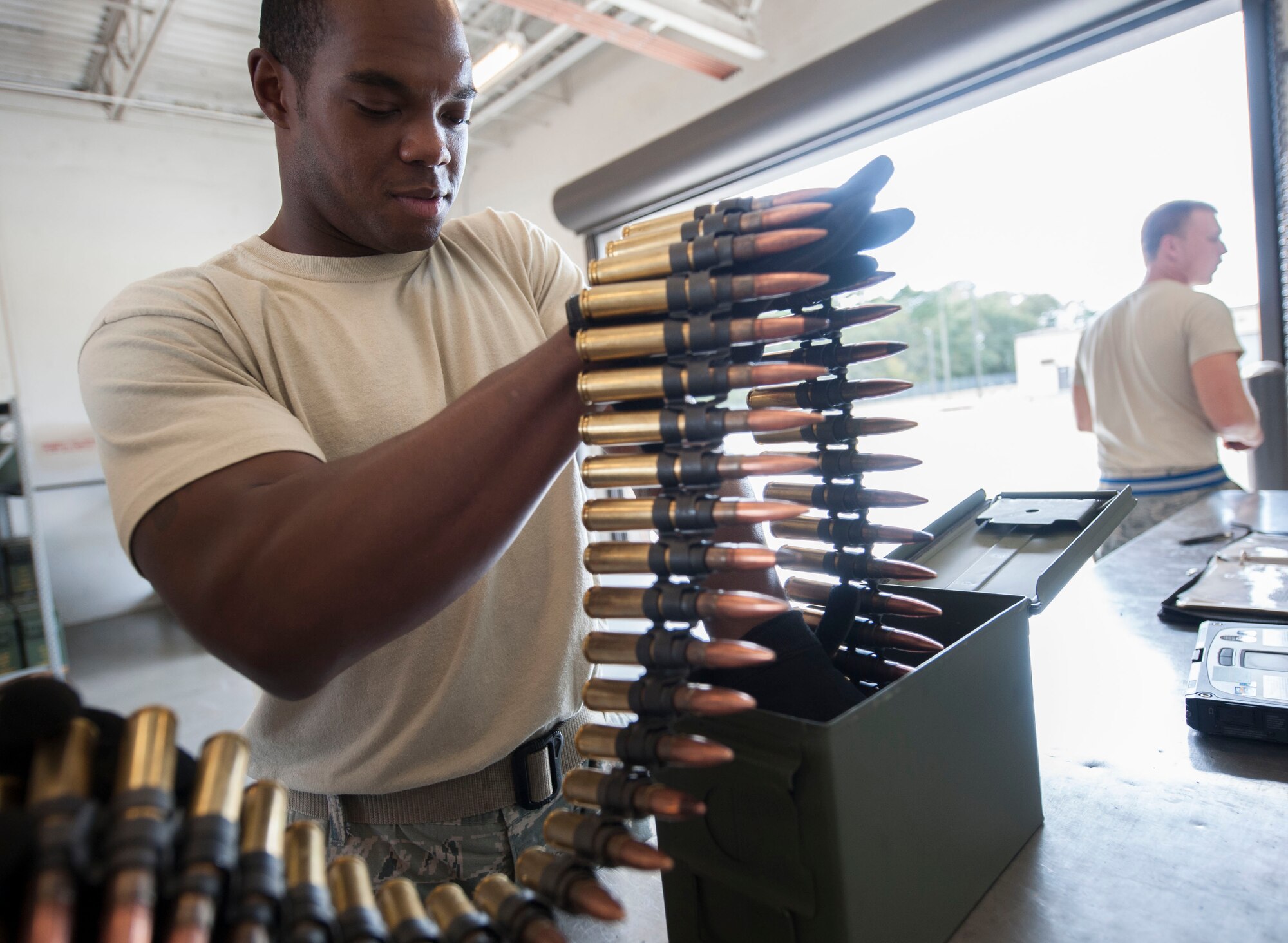 U.S. Air Force Staff Sgt. Will Brown, 23d Equipment Maintenance Squadron conventional maintenance crew chief, inspects 50-caliber rounds at Moody Air Force Base, Ga., Oct. 31, 2013. The inspection ensures the rounds are functional and have no dents, cracks or punctures. (U.S. Air Force photo by Airman 1st Class Sandra Marrero/Released)
