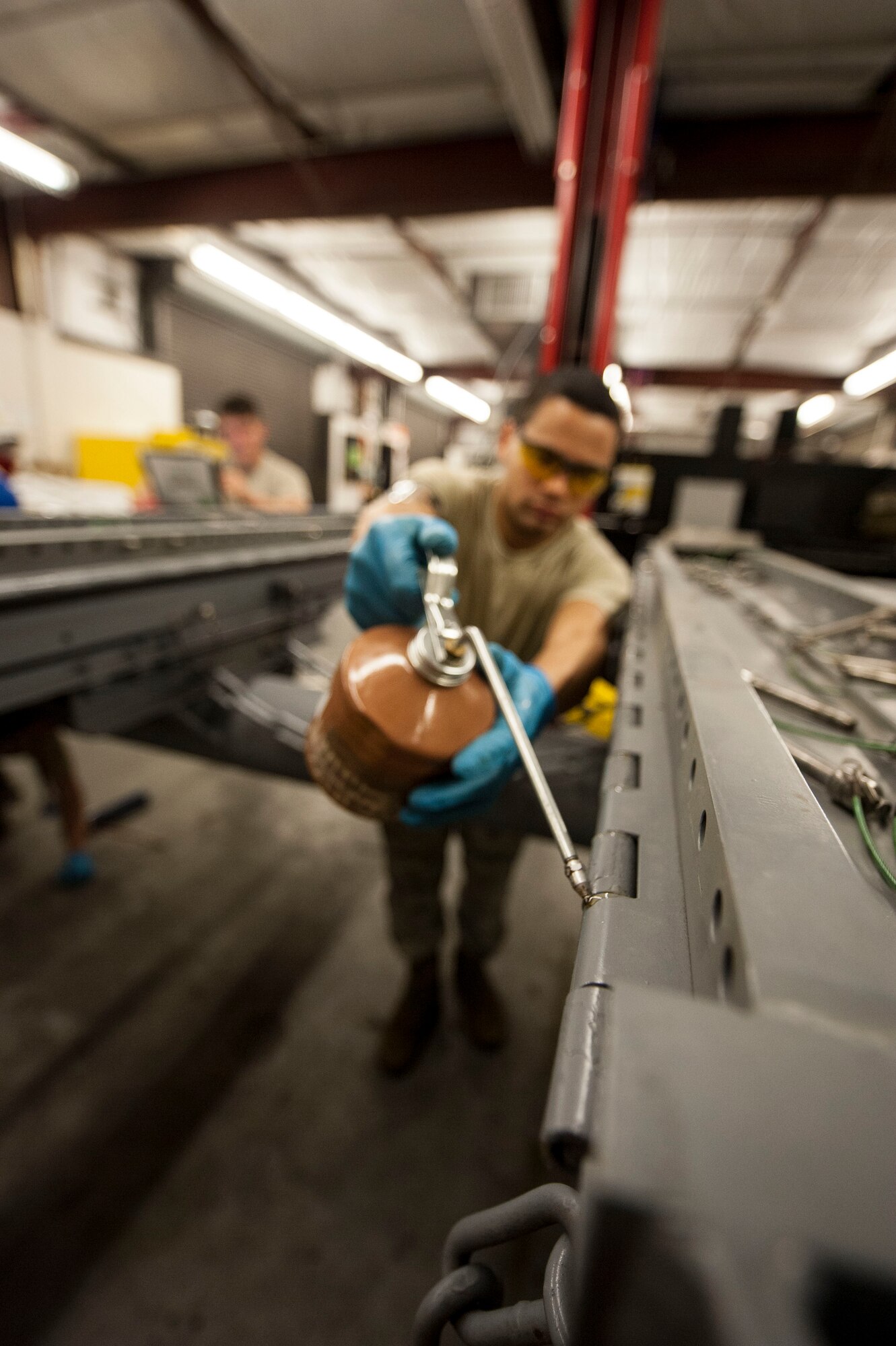 U.S. Air Force Airman 1st Class Barron English, 23d Equipment Maintenance Squadron equipment maintenance crew chief, oils an MHU-141/M munitions trailer at Moody Air Force Base, Ga., Oct. 31, 2013. Oiling the vehicle prevents wear from moving metal-to-metal parts, which helps ensure the safe transportation of munitions.  (U.S. Air Force photo by Airman 1st Class Sandra Marrero/Released)
