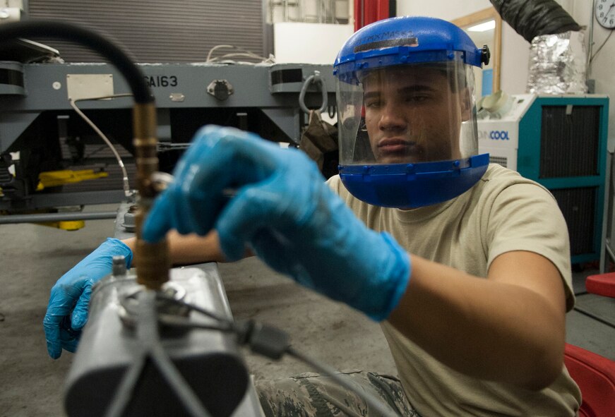 U.S. Air Force Airman 1st Class Barron English, 23d Equipment Maintenance Squadron equipment maintenance crew chief, releases air and brake fluid from an MHU-141/M munitions trailer at Moody Air Force Base, Ga., Oct. 31, 2013. Airmen release fluid and air to test the brakes on vehicles that transport munitions. (U.S. Air Force photo by Airman 1st Class Sandra Marrero/Released)