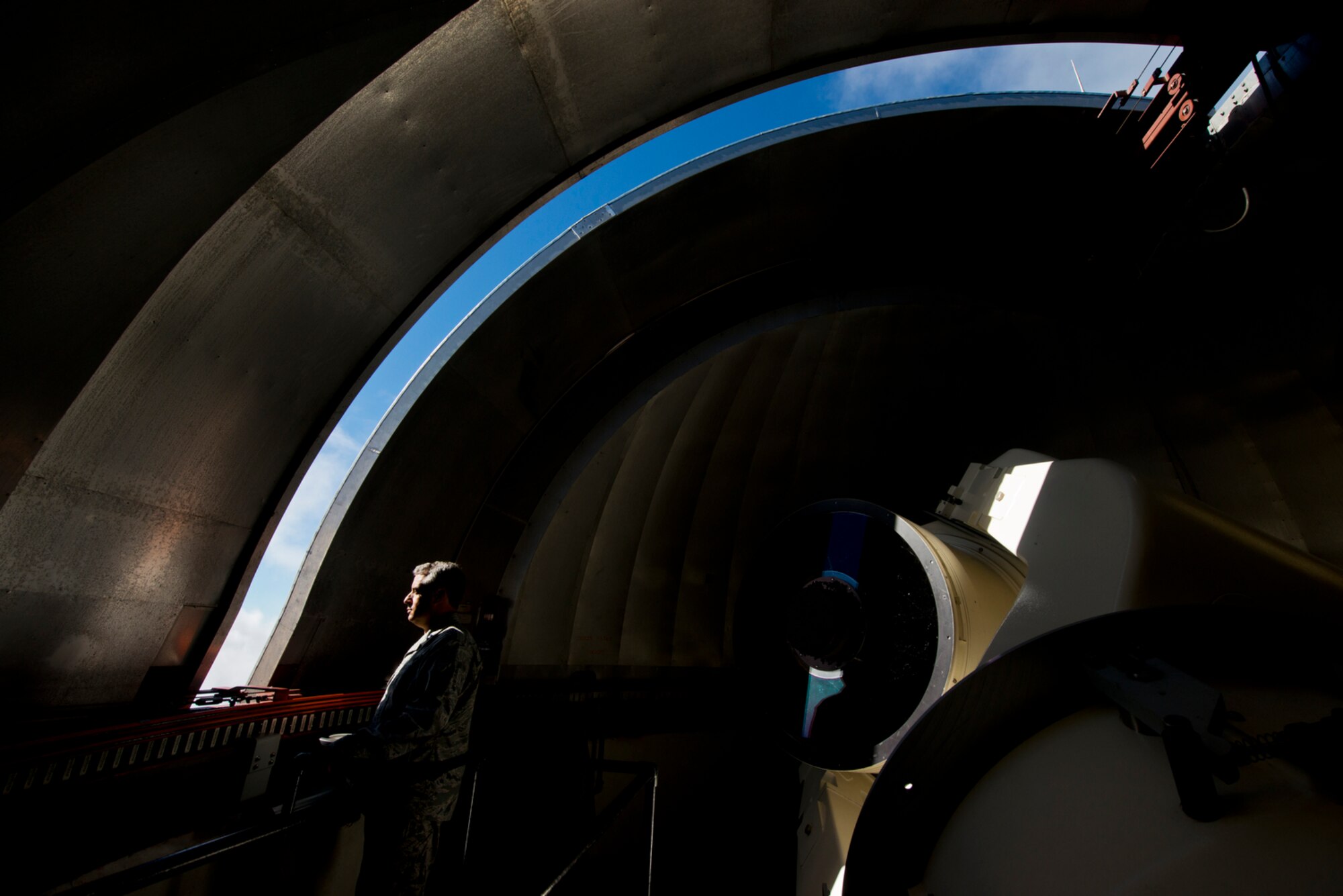 Capt. Shahn Rashid inside the housing of one of the Air Force's two 1.2 meter refractive telescope at the Maui Space Surveillance Complex. Rashid is the commander of the 21st Operations Group Detachment 3, a dedicated space surveillance unit located at the top of Mount Haleakala in Maui. (U.S. Air Force photo/Tech. Sgt. Bennie J. Davis III)