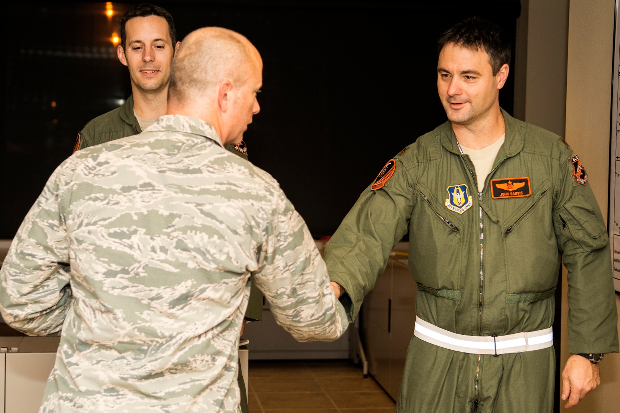 U.S. Air Force Col. Jonathan Ellis, 307th Bomb Wing commander, welcomes home Maj. John Sarvis after his return from participating in a routine exercise, Nov. 3, 2013, Barksdale Air Force Base, La. Sarvis is assigned to the 343rd Bomb Squadron, which is a classic associate unit with the 2nd BW at Barksdale. (U.S. Air Force photo by Master Sgt. Greg Steele/Released)