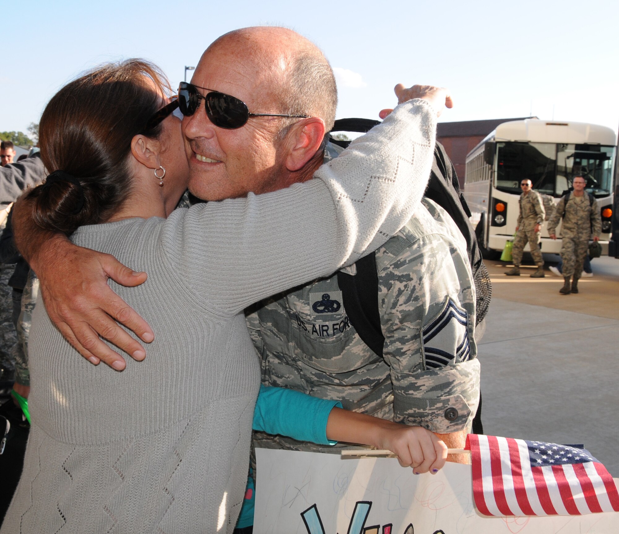 U.S. Air Force Senior Master Sgt. William K. Joyce, 192D Fighter Wing aircraft maintenance superintendent, gets well deserved hugs from his wife Carol (left) and daughter Anna (center) October 23, 2013.  After nearly a six-month deployment to Kadena Air Base, Japan, more than 200 Airmen of 192D Fighter Wing and the 27th Fighter Squadron were outfitted with the F-22 Raptor and assigned to the U.S. Pacific Command as part of a Theater Security Package rotation.  TSP deployments provide stability and security while allowing units to integrate with U.S. and Japanese forces. (U.S. Air National Guard photo by Master Sgt. Carlos J. Claudio/Released)