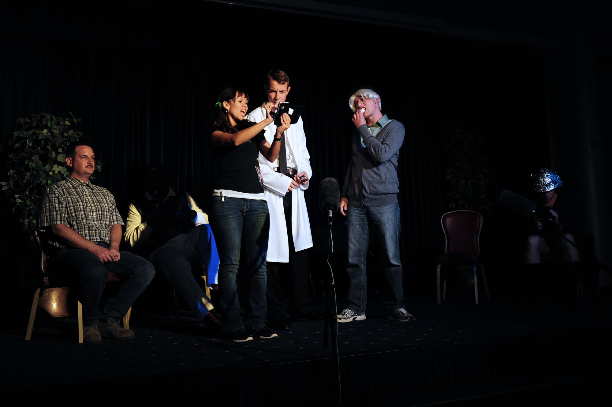 Airmen perform a group therapy comedy skit during the Saturday Night Live Incirlik 2 comedy show Nov. 2, 2013, at Incirlik Air Base, Turkey. SNLI 2 featured Airmen and civilians from a variety of ranks and backgrounds, with the common thread being a dedication to want to do something for their shared community. (U.S. Air Force photo by Airman 1st Class Nicole Sikorski/Released)