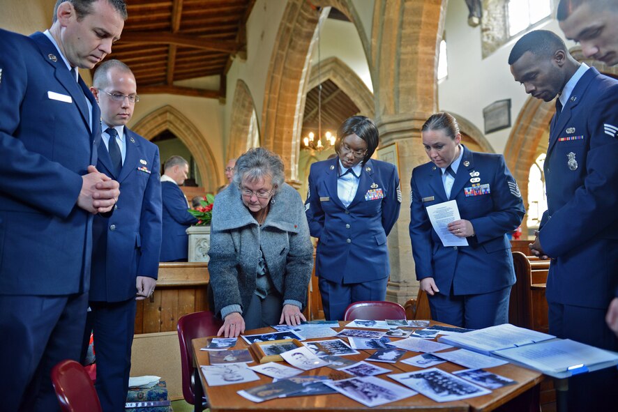 HELMDON, United Kingdom – Members of the 422nd Air Base Group and village of Helmdon look at old photos and documents of the crew of the Sharon Belle, who lost their lives in a crashed in at the Astwell Castle Farms in 1943. The village and 422nd Air Base Group held a ceremony in honor of the 327th Bombardment Squadron, VIII Bomber Command, Airmen killed Nov. 30, 1943, when they left RAF Poddington on a bombing mission to Germany, and their plane crashed at Astwell Castle Farms. (U.S. Air Force photo by Tech. Sgt. Chrissy Best)