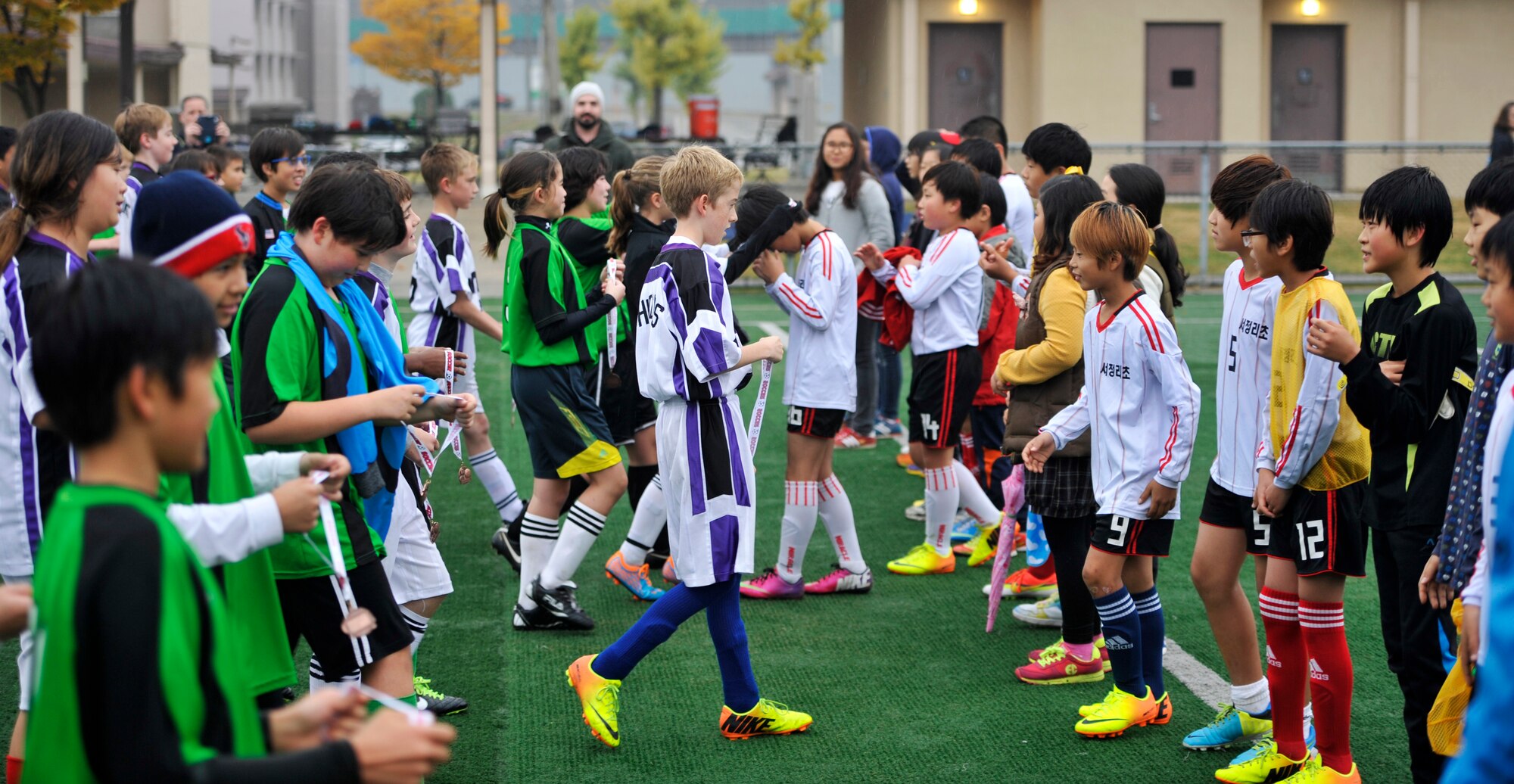 Members of Osan youth soccer teams present medallions to members of the Seojungri youth soccer team after all of the games at Osan Air Base, Republic of Korea, Nov. 2, 2013. Games like these strengthen the bond between members of the local community and the base. (U.S. Air Force photo/Staff Sgt. Emerson Nuñez)