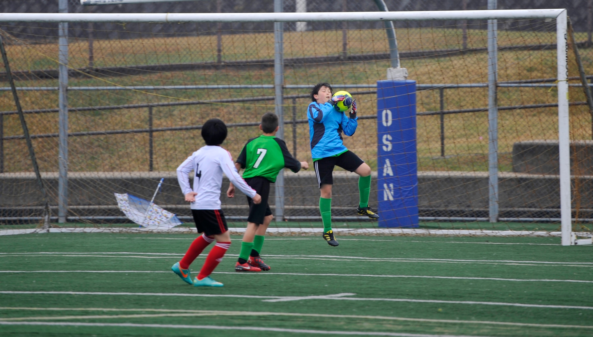 Jacob Johnson, a goalie for the Green Hornets youth soccer team, blocks a goal during a youth soccer game at Osan Air Base, Republic of Korea, Nov. 2, 2013. This is the second year that youth soccer teams from the local community have come to Osan to compete. (U.S. Air Force photo/Staff Sgt. Emerson Nuñez)