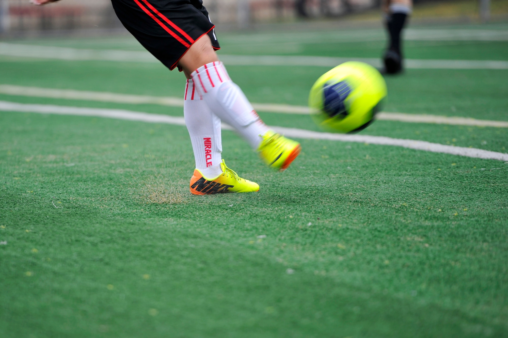 A member of the Seojungri youth soccer team kicks the ball to a teammate during a game at Osan Air Base, Republic of Korea, Nov. 2, 2013. The youth teams were made up of children aged 11 and 12. (U.S. Air Force photo/Staff Sgt. Emerson Nuñez)