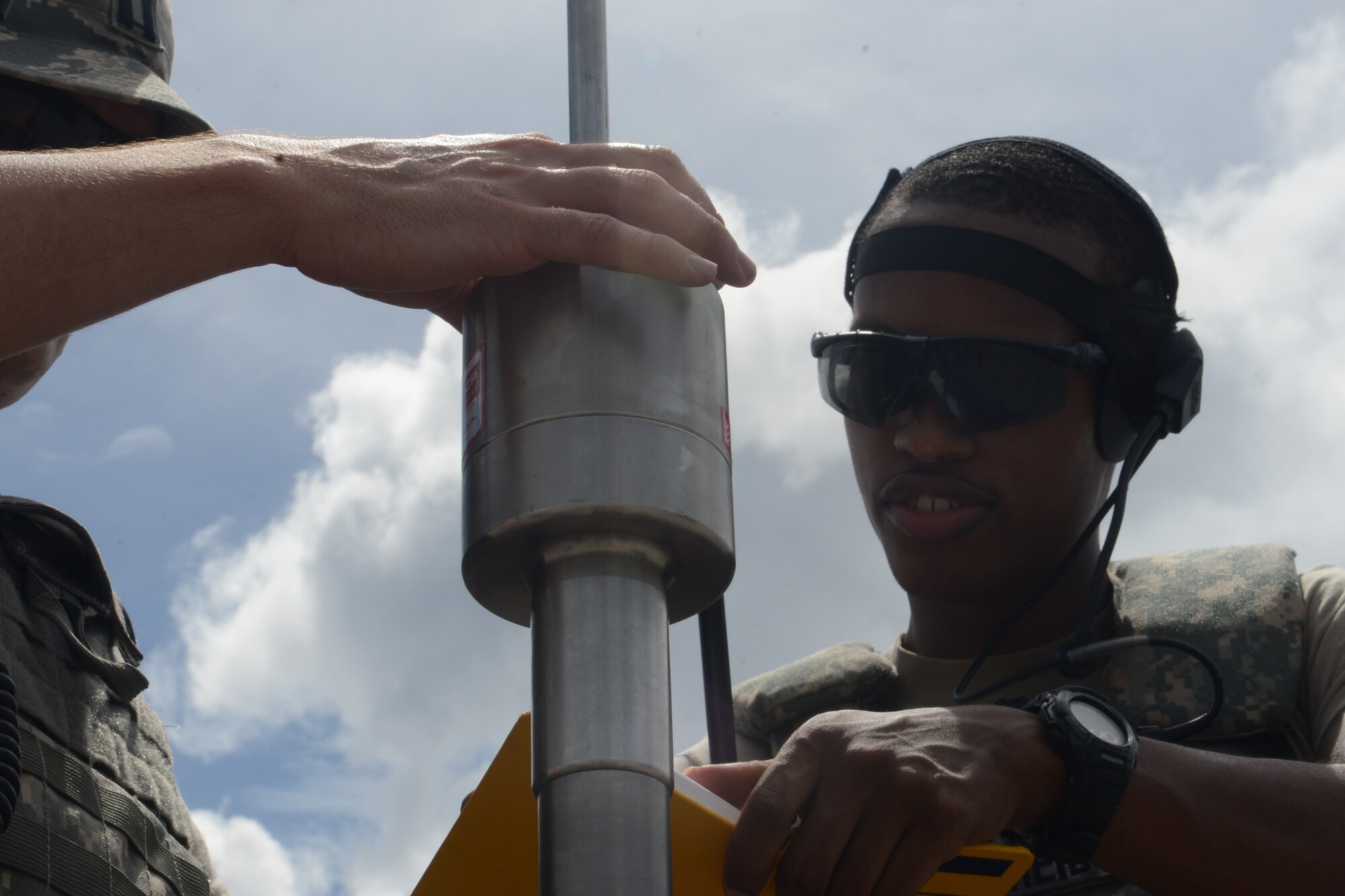 Staff Sgt. Edward Reid, 36th Mobility Readiness Squadron engineering technician, counts how many times the hammer drops on the dynamic cone penetrometer Oct. 29, 2013, on Naval Base, Guam. The technicians hammer the device into the pavement to test the durability of the pavement for follow-on Department of Defense aircraft that could potentially land without cracking the asphalt in a real-world scenario. (U.S. Air Force photo by Airman 1st Class Emily A. Bradley/Released)