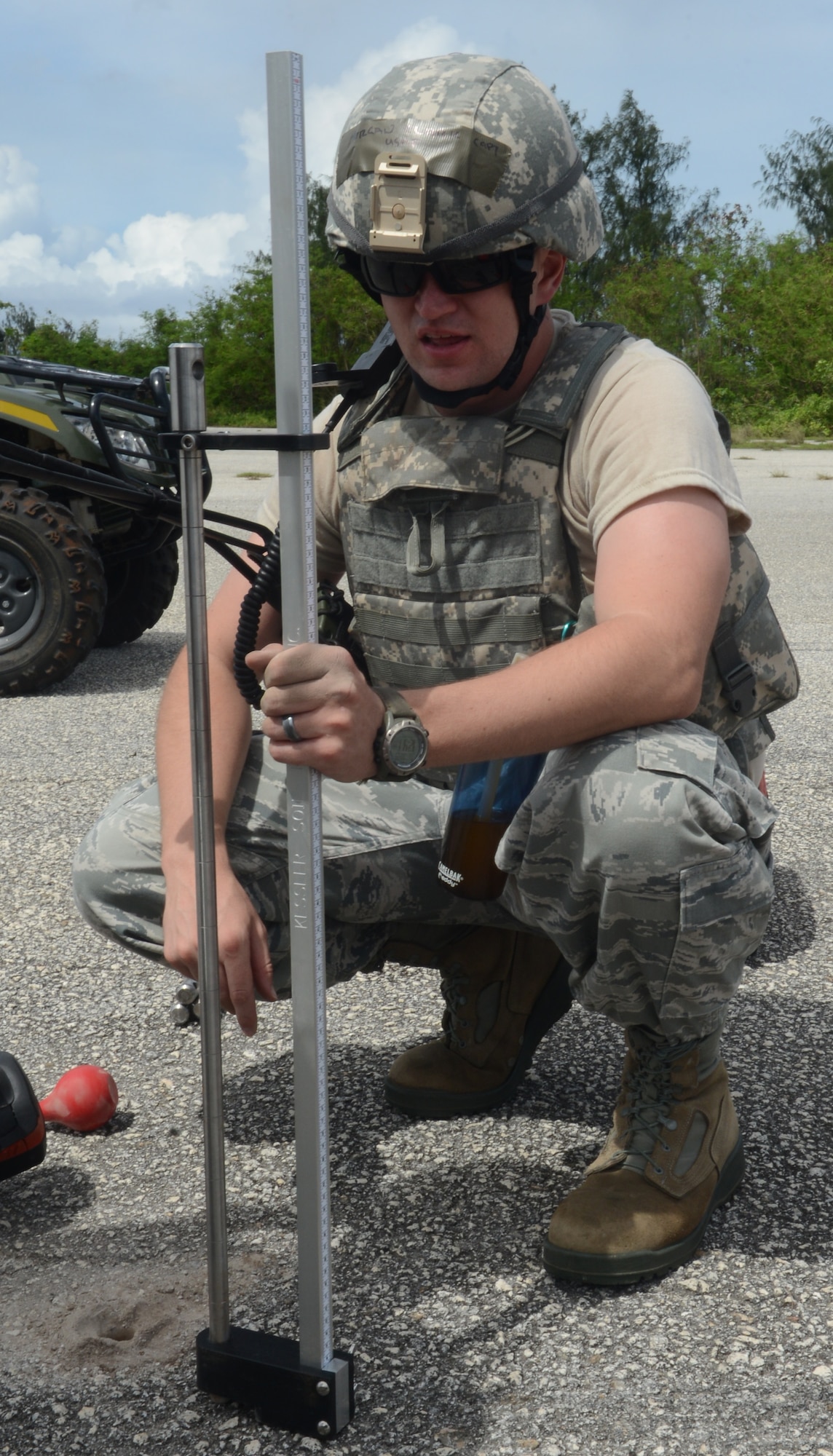 Capt. Clark Morgan, 36th Mobility Readiness Squadron officer in charge of contingency engineering, sets up the dynamic cone penetrometer to assess the durability of the pavement, Oct. 29, 2013, on Naval Base Guam. The DCP is hammered into the pavement to test if it is strong enough to handle large Department of Defense aircraft landing without cracking the asphalt so the airstrip will remain usable. (U.S. Air Force photo by Airman 1st Class Emily A. Bradley/Released)