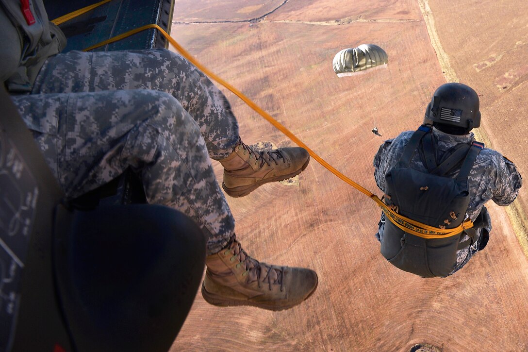 Members of the 19th Special Forces Group conduct free-fall and static line parachute jumps from a UH-60 Black Hawk helicopter near Camp Williams, Utah, Oct. 30, 2013.