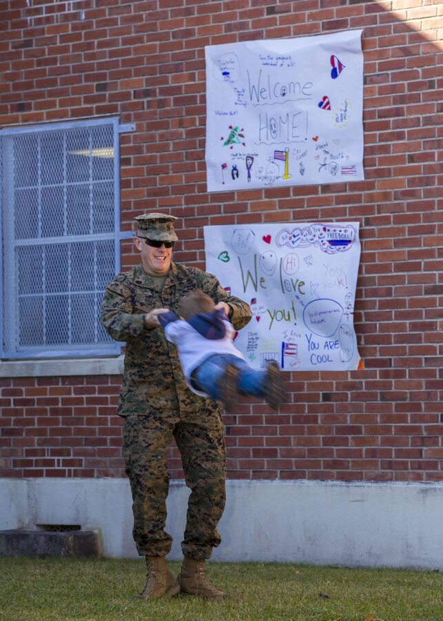 26th Marine Expeditionary Unit (MEU) command element personnel greet loved ones after arriving aboard Camp Lejeune, N.C. Nov. 4, 2013. The 26th MEU finished their eight month deployment to the U.S. 5th and 6th Fleet areas of responsibility aboard the Kearsarge Amphibious Ready Group serving as a sea-based, expeditionary crisis response force capable of conducting amphibious operations across the full range of military operations. (U.S. Marine Corps photo by Sgt. Christopher Q. Stone, 26th MEU Combat Camera/Released)