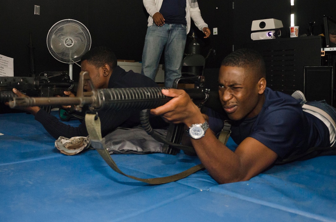 Stanford Leach, a member of Marine Corps Recruiting Station Baltimore’s Delayed Entry Program and a native of Baltimore, Md., takes aim with a M16A2 service rifle during a simulation at 4th Combat Engineer Battalion’s headquarters in Parkville, Md., Oct. 12, 2013. Recruiters from RS Baltimore brought 35 members from their Delayed Entry Program to 4th CEB’s Indoor Simulated Marksmanship Trainer (ISMT) facility in order to familiarize them with the Marine Corps and marksmanship training. (U.S. Marine Corps photo by Cpl. Bryan Nygaard/Released)