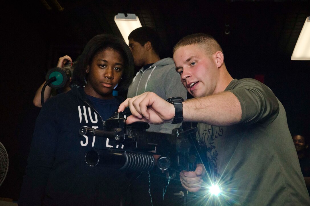 U.S. Marine Corps Pfc. Michael A. Lewis Jr., a Marine currently assigned to recruiter assistance at Marine Corps Recruiting Station Baltimore and a native of Baldwin, Md., shows Aisha Green, a member of RS Baltimore’s Delayed Entry Program, how to sight in an M16A2 service rifle during a simulation at 4th Combat Engineer Battalion’s headquarters in Parkville, Md., Oct. 12, 2013. Recruiters from RS Baltimore brought 35 members from their Delayed Entry Program to 4th CEB’s Indoor Simulated Marksmanship Trainer (ISMT) facility in order to familiarize them with the Marine Corps and marksmanship training. (U.S. Marine Corps photo by Cpl. Bryan Nygaard/Released)