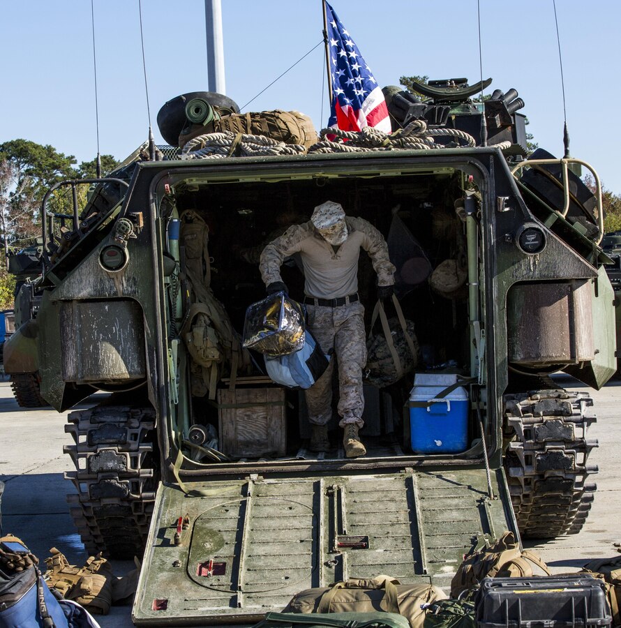 U.S. Marine Cpl. Ryan Butschley, an Amphibious Assault Vehicle (AAV) crew chief, from Pittsburg, Penn. assigned to AAV Platoon, Battalion Landing Team 3/2, 26th Marine Expeditionary Unit (MEU), offload an AAV after returning from an eight-month deployment with the 26th MEU aboard Camp Lejeune, N.C., Nov. 3, 2013. The 26th MEU is a Marine Air-Ground Task Force returning home from being forward-deployed to the U.S. 5th Fleet and 6th Fleet areas of responsibility aboard the Kearsarge Amphibious Ready Group.  They served as a sea-based, expeditionary crisis response force capable of conducting amphibious operations across the full range of military operations. (U.S. Marine Corps photo by Lance Cpl. Joshua W. Brown/Released)