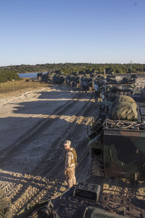 U.S. Marines assigned to Amphibious Assault Vehicle (AAV) Platoon, Battalion Landing Team 3/2, 26th Marine Expeditionary Unit (MEU), drive their AAVs through Camp Lejeune, N.C., coming home to the United States after an eight month deployment Nov. 3, 2013. The 26th MEU is a Marine Air-Ground Task Force returning home from being forward-deployed to the U.S. 5th Fleet and 6th Fleet areas of responsibility aboard the Kearsarge Amphibious Ready Group.  They served as a sea-based, expeditionary crisis response force capable of conducting amphibious operations across the full range of military operations. (U.S. Marine Corps photo by Cpl. Michael S. Lockett/Released)