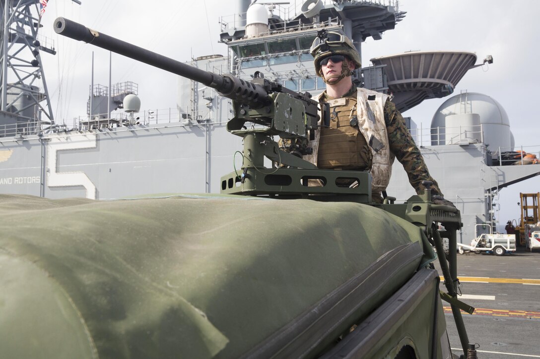 U.S. Marine Corps Lance Cpl. Zachery Oberdorfer, a machine gunner with First Battalion, Sixth Marine Regiment, 22nd Marine Expeditionary Unit (MEU), and native of Cranford, N.J., prepares an M2 .50-caliber Browning machine gun during strait crossing training aboard the USS Bataan (LHD 5), off the East Coast, during the Amphibious Ready Group (ARG)/MEU Exercise Nov. 1, 2013. The MEU is currently taking part in ARG/MEU Ex in preparation for its scheduled 2014 deployment to the U.S. 5th and 6th Fleet areas of responsibility with the Bataan ARG as a sea-based, expeditionary crisis response force capable of conducting amphibious missions across the full range of military operations. (U.S. Marine Corps photo by Sgt. Alisa J. Helin/Released)