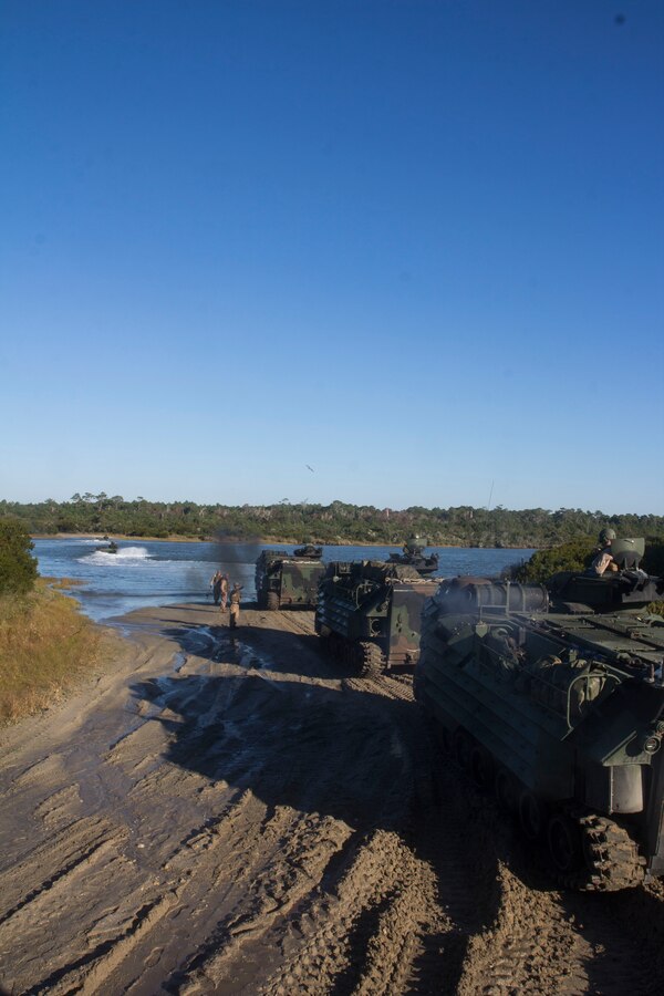 U.S. Marines assigned to Amphibious Assault Vehicle (AAV) Platoon, Battalion Landing Team 3/2, 26th Marine Expeditionary Unit (MEU), drive their AAVs through Camp Lejeune, N.C., coming home to the United States after an eight month deployment Nov. 3, 2013. The 26th MEU is a Marine Air-Ground Task Force returning home from being forward-deployed to the U.S. 5th Fleet and 6th Fleet areas of responsibility aboard the Kearsarge Amphibious Ready Group.  They served as a sea-based, expeditionary crisis response force capable of conducting amphibious operations across the full range of military operations. (U.S. Marine Corps photo by Cpl. Michael S. Lockett/Released)