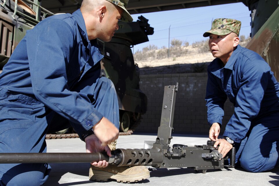 Sgt. 1st Class Yoji Yamaguchi and Master Sgt. Yasushi Yamakawa assemble a .50 caliber machine gun during the Amphibious Assault Crewman Course Nov. 5. Members of the Japanese Ground Self-Defense Force are training with Marines to prepare for receiving their own Assault Amphibious Vehicles. Yamaguchi and Yamakawa are both members of the JGSDF and are currently students in the AAC Course. 