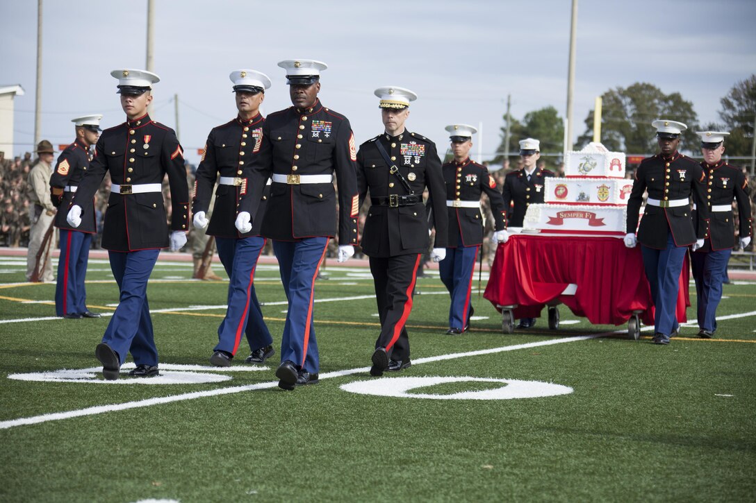 U.S. Marines march on the ceremonial cake during the Joint Daytime Ceremony aboard Camp Lejeune, N.C., Nov. 6, 2013. The ceremony is held every year in honor of the Marine Corps birthday. (U.S. Marine Corps photo by Lance Cpl. Andre Dakis, COMCAM, MCI-East, Camp Lejeune/Released)