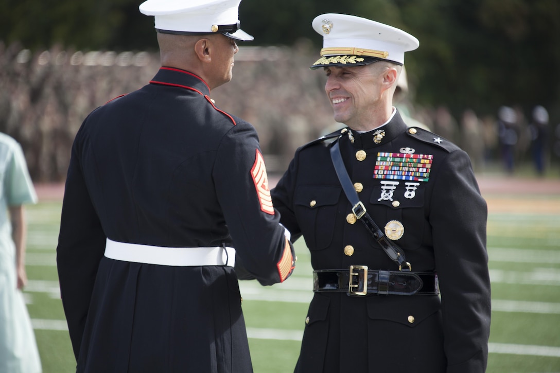 U.S. Marines Sgt. Maj. Ernest K. Hoopii, left, sergeant major, Marine Corps Installations East (MCI-E) shakes hands with Brig. Gen. Robert F. Castellvi, right, commanding general, MCI-E after the Joint Daytime Ceremony aboard Camp Lejeune, N.C., Nov. 6, 2013. The ceremony is held every year in honor of the Marine Corps birthday. (U.S. Marine Corps photo by Lance Cpl. Andre Dakis, COMCAM, MCI-East, Camp Lejeune/Released)