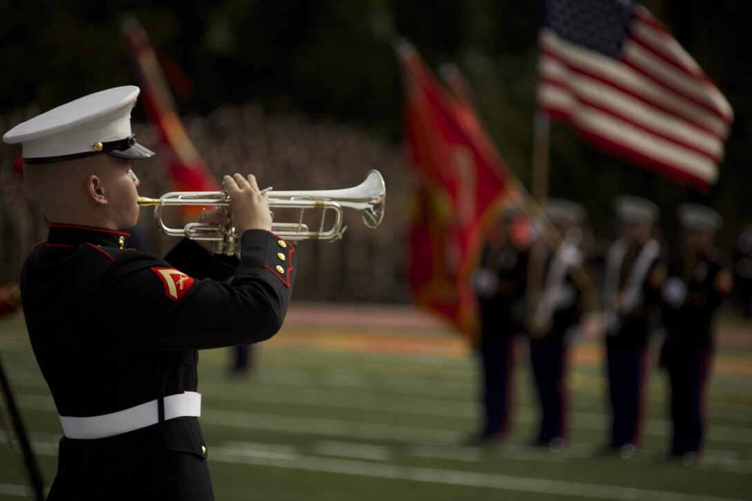 A U.S. Marine with the 2nd Marine Division band plays "TAPS" in honor of the fallen Marines during the Joint Daytime Ceremony aboard Camp Lejeune, N.C., Nov. 6, 2013. The traditional ceremony is held every year in honor of the Marine Corps birthday. (U.S. Marine Corps photo by Cpl. Adrian Weekly, Combat Camera, MCB Camp Lejeune/Released)