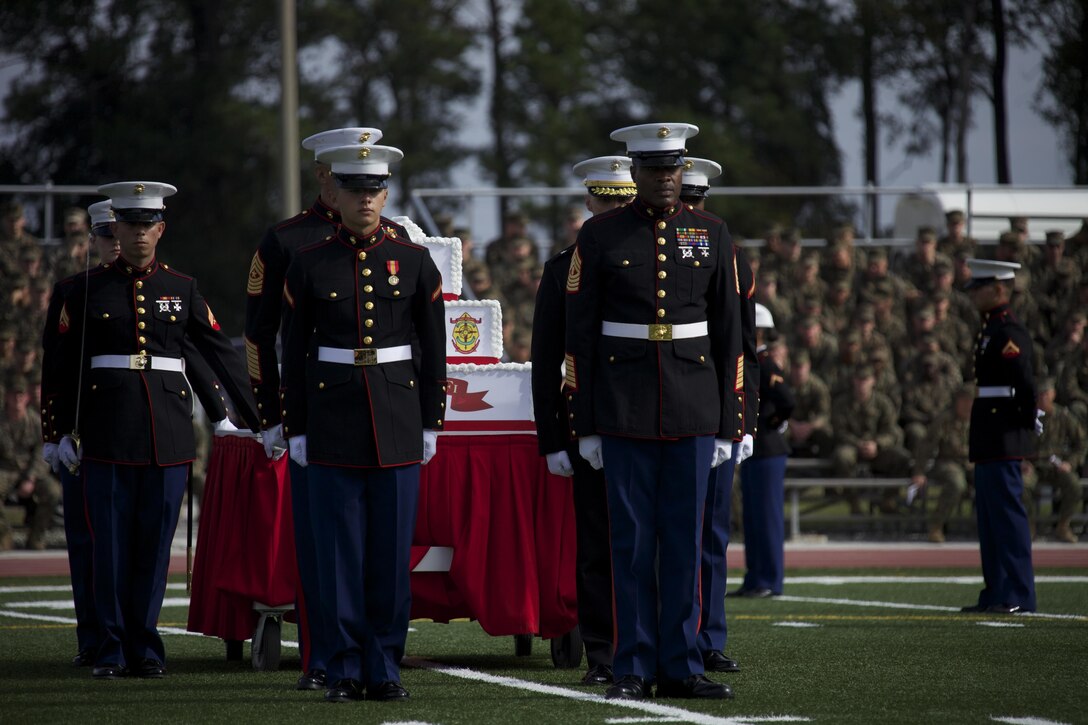 U.S. Marines stand at attention prior to the presentation of the birthday cake to the oldest and youngest Marines during the Joint Daytime Ceremony aboard Camp Lejeune, N.C., Nov. 6, 2013. The traditional ceremony is held every year in honor of the Marine Corps birthday. (U.S. Marine Corps photo by Cpl. Adrian Weekly, Combat Camera, MCB Camp Lejeune/Released)