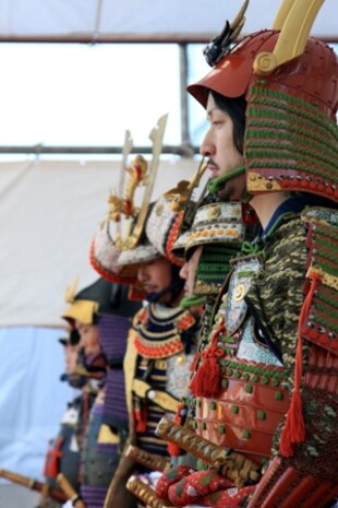 Local Japanese volunteers stand aligned during the samurai stage performance of the 22nd Kuragake Castle Festival in Kuga, Iwakuni City, Nov. 20. Event coordinators hope to broaden the spectrum of Marine volunteers over time, and in the near future, have a full squad of Marine volunteers during the event.
