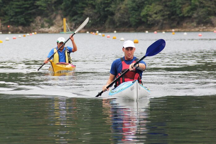 Capt. Peter Vergenz, Marine Aviation Logistics Squadron 12 assistant operations officer, speeds toward the finish line as an Iwakuni local tries to catch up to him during a practice kayak race at Nakayama Lake Oct. 1. Iwakuni City announced the competition to promote a friendly atmosphere within the community and bring attention to the national-level kayak competition, which took place Oct. 6.