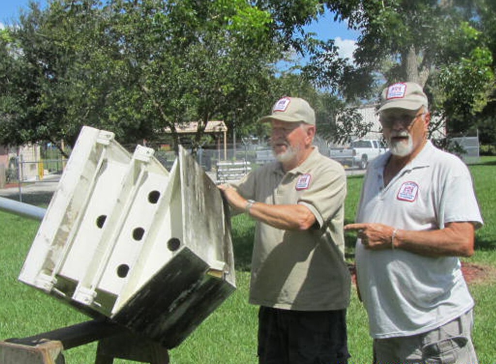 W.P. Franklin Lock and Dam Recreation Area volunteers Don Chapman (left) and George Schisler clean and repair one of the many Purple Martin “palaces” that they have built over the years, in preparation for the return of Purple Martin colonies in January.

