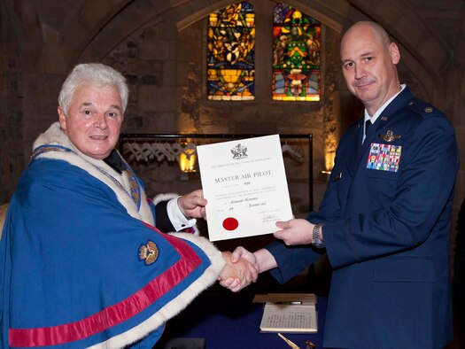 Lt. Col. Alexander Neumann, 1st Special Operations Squadron, chief pilot, receives a Master Air Pilot certificate from the Guild of Air Pilots and Air Navigators' based in London, England, during a banquet held Oct. 23 at the Guildhall in London.  The award, signed by His Royal Highness, Prince Andrew, Duke of York, is used to recognized pilots and navigators, civilian and military from various branches of professional flying who have distinguished themselves in their profession by consistently exceeding the standard in flying throughout their career.  (Photo Courtesy of Gerald Sharp Photography)
