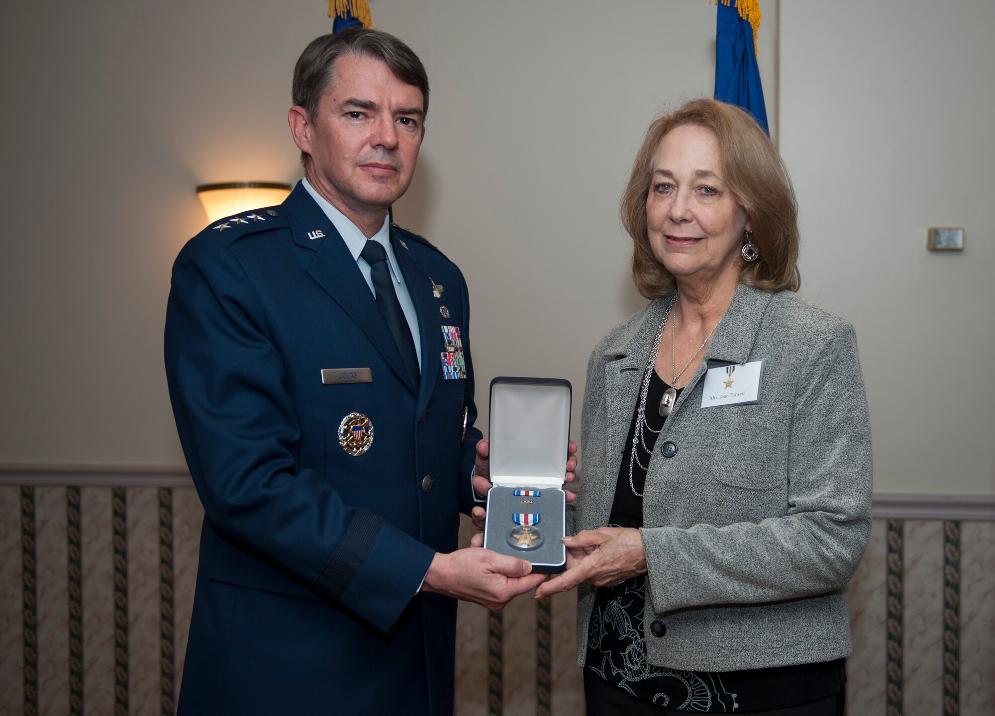 FORT MYER, Va.- Lt. Gen. Jan-Marc Jouas, 7th Air Force commander, presents the Silver Star to Mrs. Jane Tidwell, accepting on behalf of Capt. Robert Tidwell for gallantry in action, Fort Myer, Va., Nov. 1, 2013, Tidwell piloted the sole anti-radiation missile aircraft, the F-4C Wild which provided close air support for B-52’s during Linebacker II during the Vietnam War, on Dec. 28, 1972. (U.S. Air Force photo by Staff Sgt. Carlin Leslie)