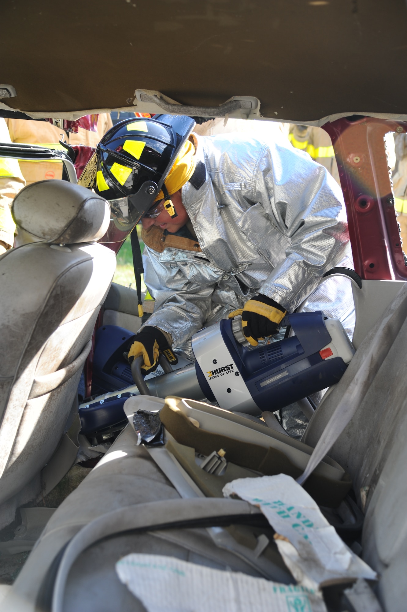 Staff Sgt. Jared Lott, Keesler firefighter, uses new battery powered jaws of life equipment to remove the entire side of a vehicle during a two-day joint auto extrication training Nov. 5, 2013, at Keesler Air Force Base, Miss.  The training was joint with Biloxi Firefighters. Keesler and Biloxi Fire Departments conduct several joint training sessions a year to include: live fire structural burn, auto and a variety of other classes.  (U.S. Air Force photo by Kemberly Groue)