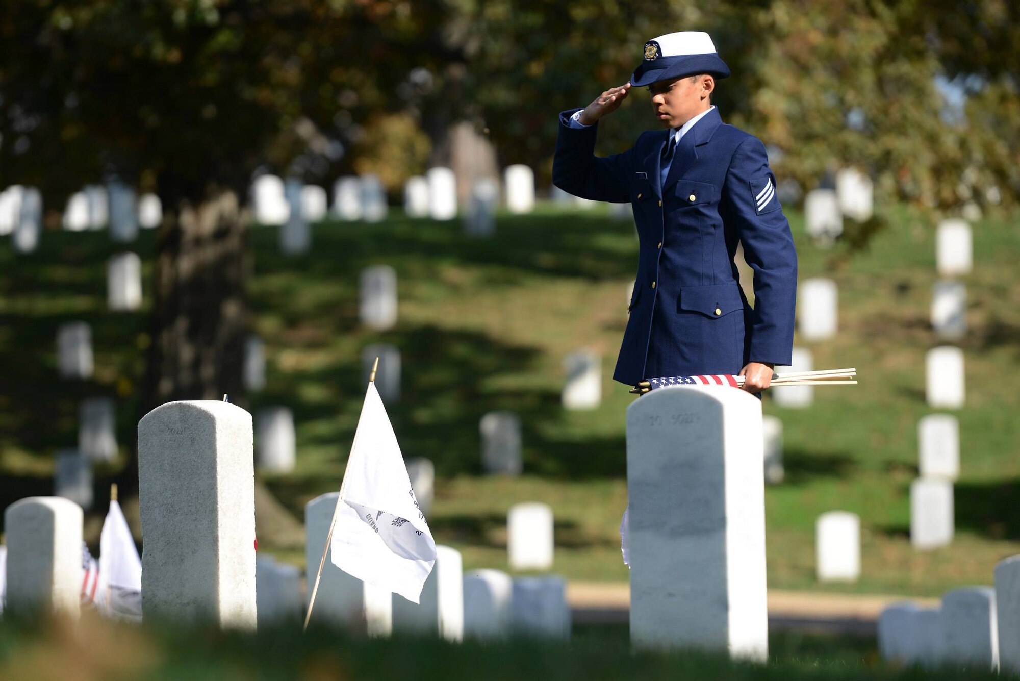 Seaman Samantha Sanders salutes to honor a Coast Guard veteran at Arlington National Cemetery. Seaman Sanders is the niece of Senior Master Sgt. Carla Jeffcoat, 94LRS maintenance supply liaison, and she is scheduled to graduate from the Coast Guard's basic training program on Nov. 15, 2013.  U.S. Coast Guard photo by Petty Officer 2nd Class Patrick Kelley.