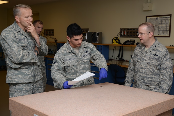 Airmen 1st Class Kasey Ray, 437th Maintenance Squadron Precision Measurement Equipment Laboratory technician gives Col. Jeff DeVore, Joint Base Charleston commander, and Col. Darren Hartford, 437th Airlift Wing commander, a brief synopsis of his job Nov. 5, 2013, at Joint Base Charleston – Air Base, S.C. DeVore visited several different squadrons to include 437th NDI, 437th Precision Measurement Equipment Laboratory, the Passenger Terminal, as well as the 373rd Training Squadron, Detachment 5 as part of an immersion to learn about the 437 AW (U.S. Air Force photo/ Airman 1st Class Chacarra Neal)