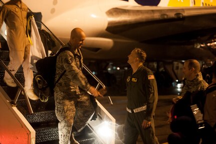 Colonel Darren Hartford, 437th Airlift Wing commander, shakes hands with Tech. Sgt. Jason Hoffman, 14th Airlift Squadron loadmaster, as he exits the plane returning to Joint Base Charleston — Air Base, S.C. November 2, 2013 from his deployment. (U.S. Air Force photo/Airman 1st Class Michael Reeves)