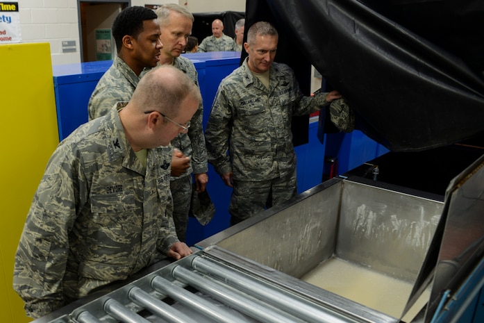 Staff Sgt. Brian Farley, 437th Maintenance Squadron Non-Destructive Inspection inspector gives Col. Jeff DeVore, Joint Base Charleston commander, Col. Darren Hartford, 437th Airlift Wing commander, and Col. James Fontanella, 315th Airlift Wing commander, a brief synopsis of his job Nov. 5, 2013, at Joint Base Charleston – Air Base, S.C. DeVore visited several different squadrons to include 437th NDI, 437th Precision Measurement Equipment Laboratory, the Passenger Terminal, as well as the 373rd Training Squadron, Detachment 5 as part of an immersion to learn about the 437 AW. (U.S. Air Force photo/ Airman 1st Class Chacarra Neal)