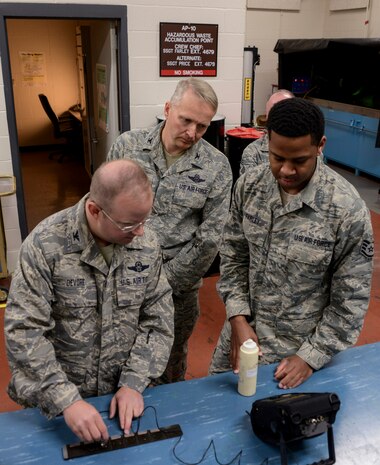Staff Sgt. Brian Farley, 437th Maintenance Squadron Non-Destructive Inspection inspector gives Col. Jeff DeVore, Joint Base Charleston commander,  and Col. Darren Hartofrd, 437th Airlift Wing commander , a brief synopsis of his job Nov. 5, 2013, at Joint Base Charleston – Air Base, S.C. DeVore visited several different squadrons to include 437th NDI, 437th Precision Measurement Equipment Laboratory, the Passenger Terminal, as well as the 373rd Training Squadron, Detachment 5 as part of an immersion to learn about the 437 AW. (U.S. Air Force photo/ Airman 1st Class Chacarra Neal)
