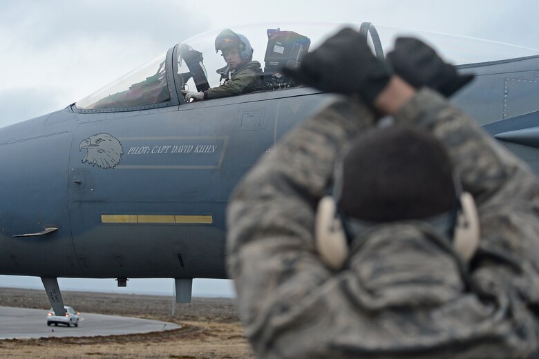 Senior Airman Kyle Eisler, 493rd Expeditionary Fighter Squadron crew chief, marshals an F-15C Eagle piloted by Lt. Col. Mark Sadler, 493rd EFS commander, Keflavik International Airport, Iceland, Nov. 4, 2013, to conduct air surveillance and policing missions. Airmen from Royal Air Force Lakenheath, RAF Mildenhall, Spangdahlem Air Base, Ramstein AB, Davis-Monthan Air Force Base, Tinker AFB and Robins AFB arrived at Keflavik International Airport, Iceland, Oct. 28, 2013, to complete an air surveillance exercise in support of a bilateral agreement between the U.S. and Iceland. (U.S. Air Force photo by Airman 1st Class Dana J. Butler)