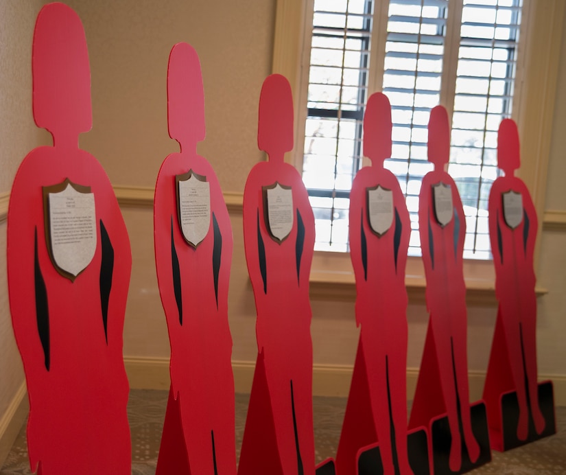 Red silhouettes stand in memory of service members who were lost due to domestic violence at a Domestic Violence Awareness luncheon October 31, 2013 at Joint Base Charleston, S.C. The luncheon featured guest speaker, Lucy Forest, whose daughter was a victim of domestic violence. (U.S. Air Force photo/Senior Airman Ashlee Galloway)