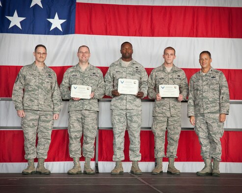 Col. Todd McCubbin, 934th Airlift Wing commander, and Chief Master Sgt. Bryan Payne, 934 AW command chief, present the 934 AW Quarterly Awards for the second quarter to winners (center, left to right) Senior Master Sgt. Todd Littfin, Tech. Sgt. Robert Murphy, and Senior Airman Tanner Ladsten. Not pictured is Capt. Ethan Bryan who was unable to be present.  (U.S. Air Force photo/Shannon McKay)