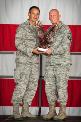 Col. Todd McCubbin, 934th Airlift Wing commander, presents Senior Master Sgt. Peter DeSanctis, 934th Maintenance Squadron, with tthe Air Force Reserve Command's Outstanding Airman of the Year award during the November Unit Training Assembly's commander's call at the Minneapolis-St. Paul Air Reserve Station, Minn.  (U.S. Air Force photo/Shannon McKay)