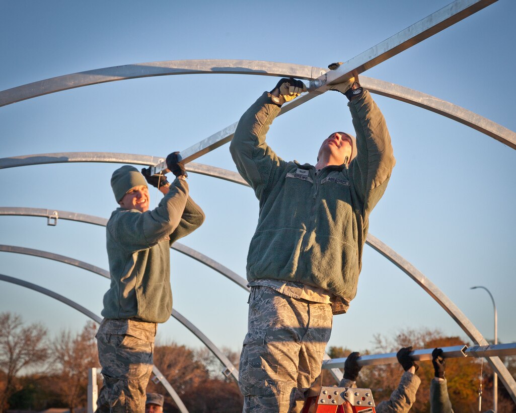 Tech Sgts. Marc Grewe and Kyle Sunne, 934th Civil Engineering Squadron, place support cross pieces while assembling an Alaska tent. Members of the 934 CES and 934th Force Support Squadron practiced setting up and tearing down the shelters during the November Unit Training Assembly weekend at the Minneapolis-St. Paul Air Reserve Station, Minn.  (U.S. Air Force photo/Shannon McKay)