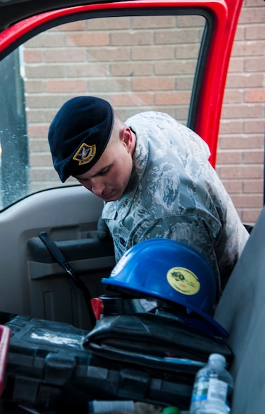 Airman 1st Class Tanner Mansuetti, 5th Security Forces Squadron installation entry controller, checks the inside of a truck during a routine security inspection here, Nov. 6, 2013. Mansuetti works long hours to keep the base safe and secure. (U.S. Air Force photo/Airman 1st Class Andrew Crawford)
