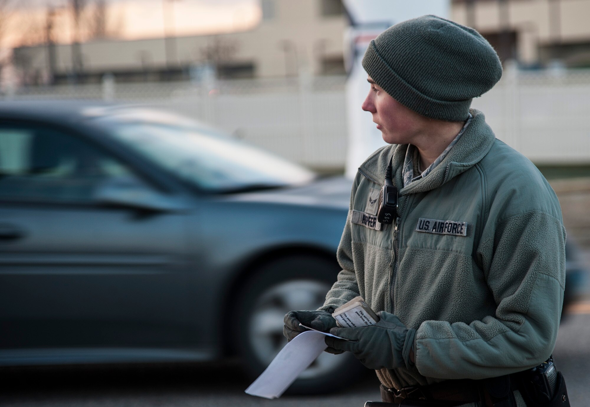 Airman 1st Class Frances Hopfer, 5th Security Forces Squadron installation entry controller, awaits the next car pulling into the search pit here, Nov. 6, 2013. Hopfer works on a team checking vehicles entering the base. (U.S. Air Force photo/Airman 1st Class Andrew Crawford)