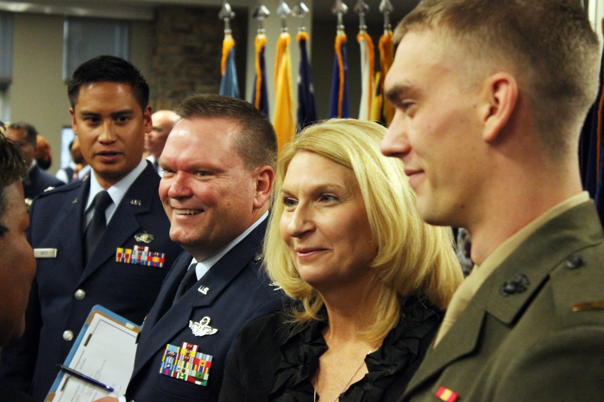 BUCKLEY AIR FORCE BASE, Colo. -- After assuming command of Air Reserve Personnel Center, Col. Samuel "Bo" Mahaney, second from left, his wife, Chris, and their son U.S. Marine Corps 2nd Lt. Samuel Mahaney Jr. greet ARPC staff in a congratulatory line while, at left, Lt. Col. Michael Ortiz, chief, ARPC Force Development, looks on. Mahaney assumed command of ARPC from Lt. Gen. James "JJ" Jackson, commander, Air Force Reserve Commmand, in a ceremony Nov. 5, 2013, at Buckley AFB, Colo. Mahaney comes from being wing commander at 452nd Air Mobility Wing, March Air Reserve Base, Calif. (U.S. Air Force photo/Master Sgt. Christian Michael)