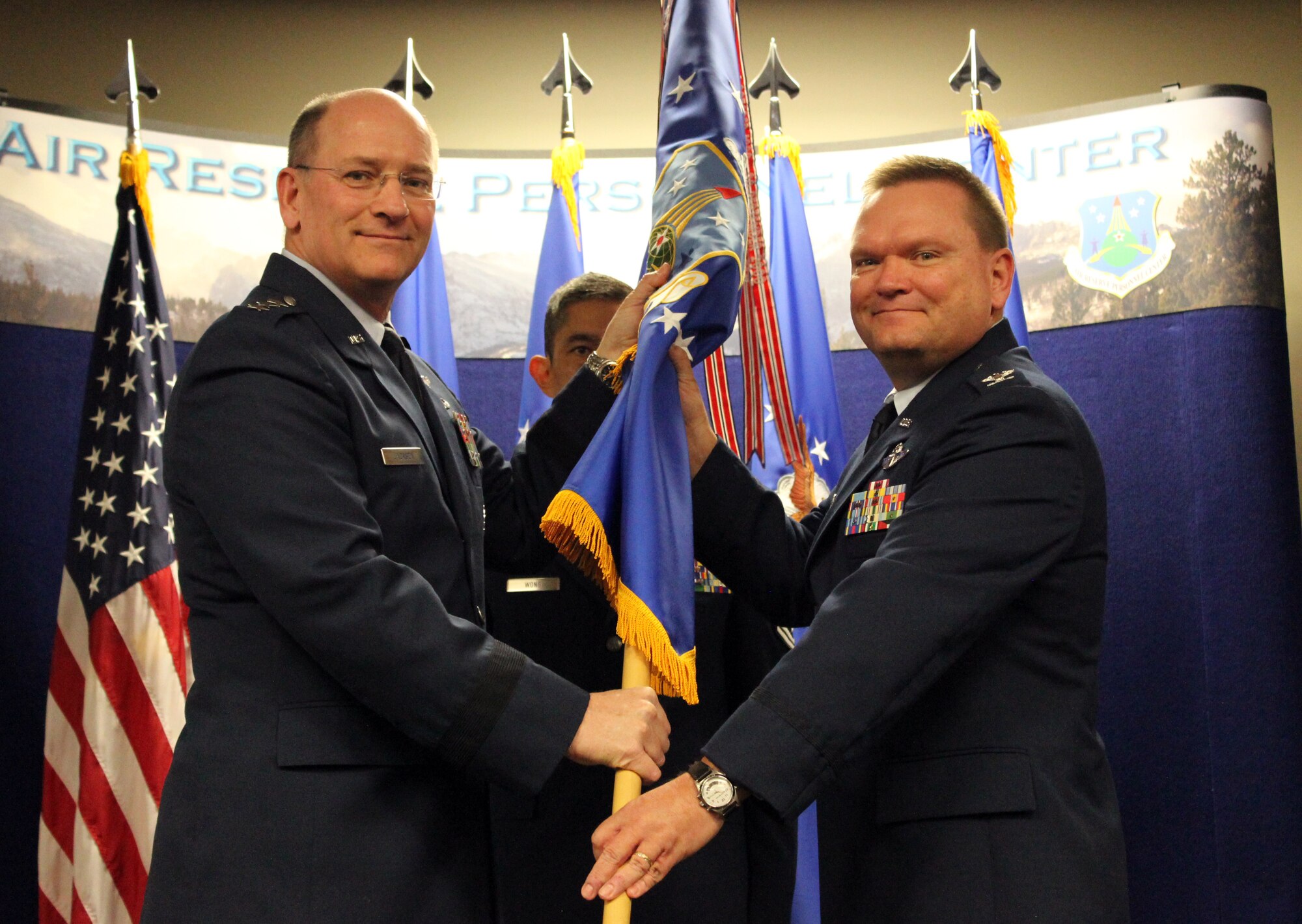 BUCKLEY AIR FORCE BASE, Colo. -- Col. Samuel "Bo" Mahaney assumed command of Air Reserve Personnel Center from Lt. Gen. James "JJ" Jackson, commander, Air Force Reserve Commmand, while ARPC Command Chief Master Sgt. Brian Wong looks on in a ceremony Nov. 5, 2013, at Buckley AFB, Colo. Mahaney comes from being wing commander at 452nd Air Mobility Wing, March Air Reserve Base, Calif. (U.S. Air Force photo/Master Sgt. Christian Michael)