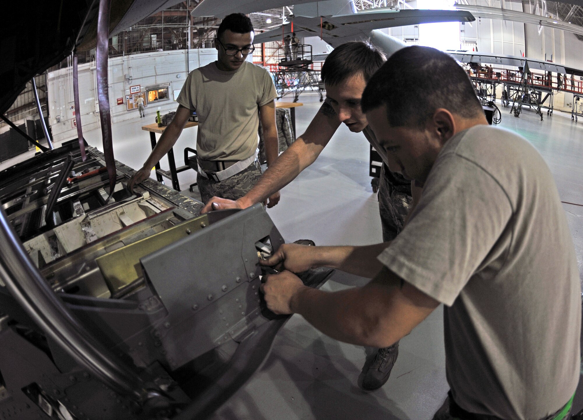 Airmen from the 317th Maintenance Squadron inspect one of the ramp hooks on a C-130J Oct. 30, 2013, at Dyess Air Force Base, Texas. The cargo ramp hooks are the primary means for securing the cargo ramp against the fuselage. (U.S. Air Force photo by Airman 1st Class Kedesha Pennant/Released)

