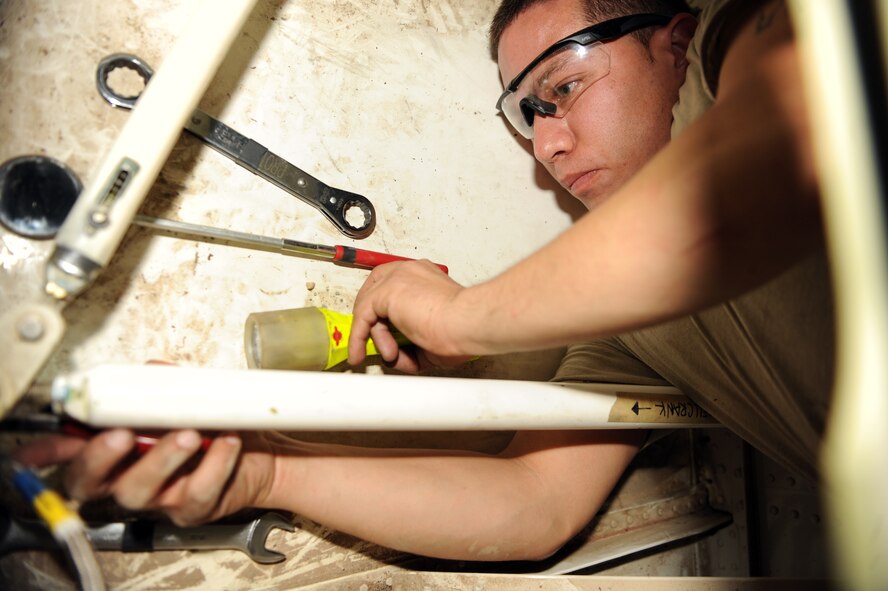 U.S. Air Force Tech. Sgt. Eric Albarran, 317th Maintenance Squadron repair and reclamation lead technician, works on the cargo ramp actuator on a C-130J Oct. 30, 2013, at Dyess Air Force Base, Texas. The cargo ramp actuator is responsible for locking and unlocking the ramp during ground and air operations. (U.S. Air Force photo by Airman 1st Class Kedesha Pennant/Released)

